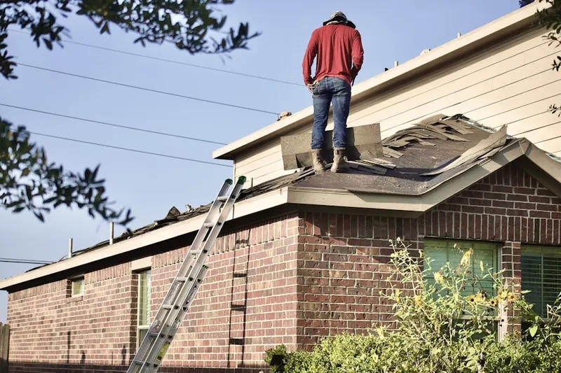 Professional roofer working on a residential roof in Holt